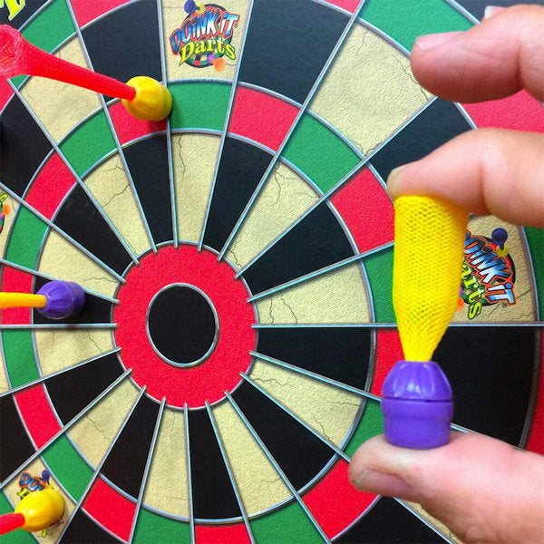 Doink it close up showing a kid's fingers holding a plastic magnetic dart