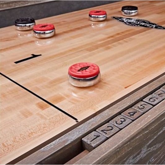 Brunswick Shuffleboard Rocks shown on shuffleboard table