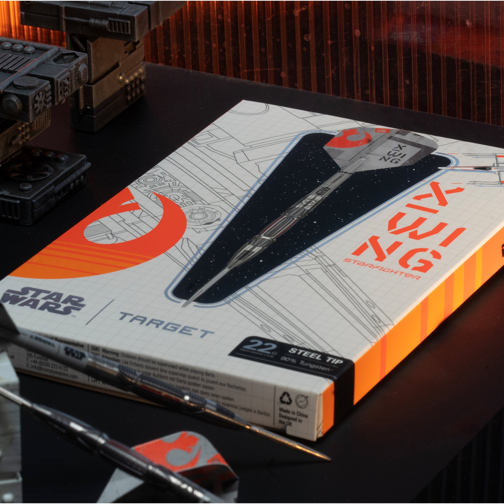 Box of Target Star Wars darts on a dark surface with darts visible Box of Target Star Wars darts on a dark surface with darts visible