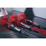 Three darts with red flights on a reflective surface