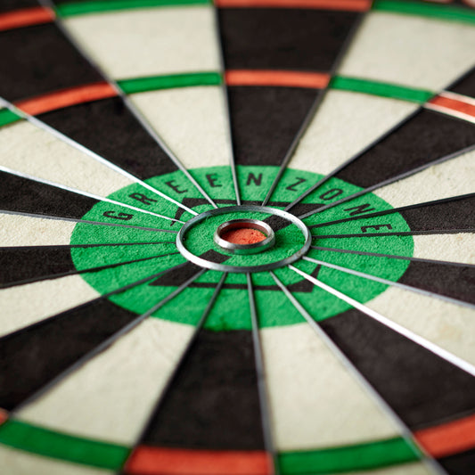 Close-up of a dartboard with a bullseye labeled 'Green Zone'.