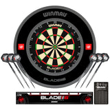 Winmau Blade 6 Triple Core dartboard, Pro-Line 1.0 black dartboard surround with darts and a dart accessories on a white background