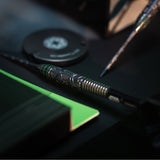 Close-up of a dart with decorative patterns on a blurred background