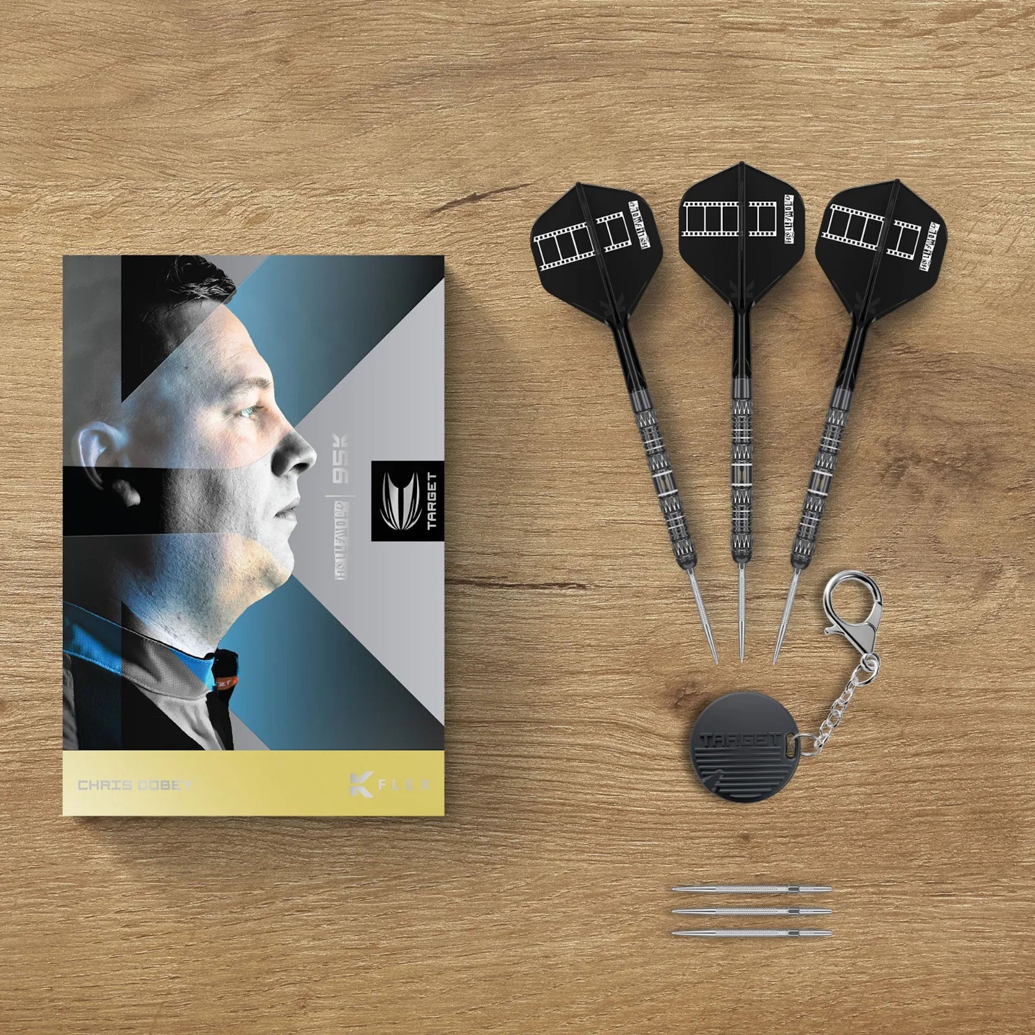 Chris Dobey 95K SP 95% Tungsten Dart set with packaging on a wooden surface
